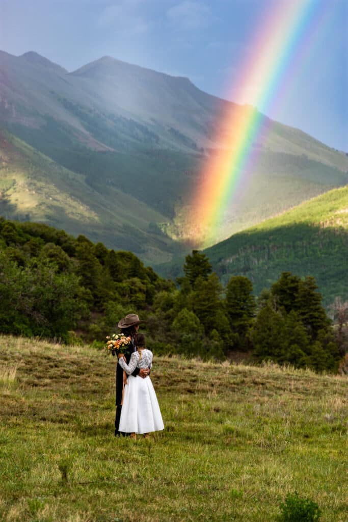 Bride and groom with rainbow in Telluride, Colorado Aldasaro Ranch wedding venue
